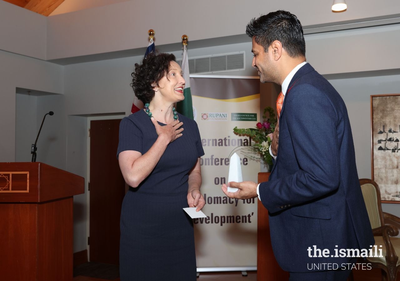 Elizabeth Horst offers a token of appreciation to Faisal Momin, President of the Ismaili Council for the Southwestern USA, for hosting the event.