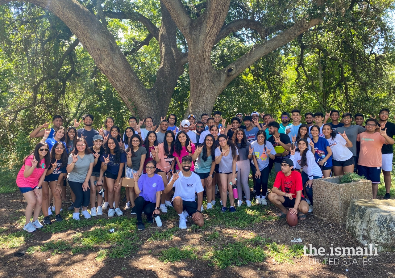 Members of the Ismaili Muslim Students Association pose with the University’s hand sign, “Hook ‘em.”