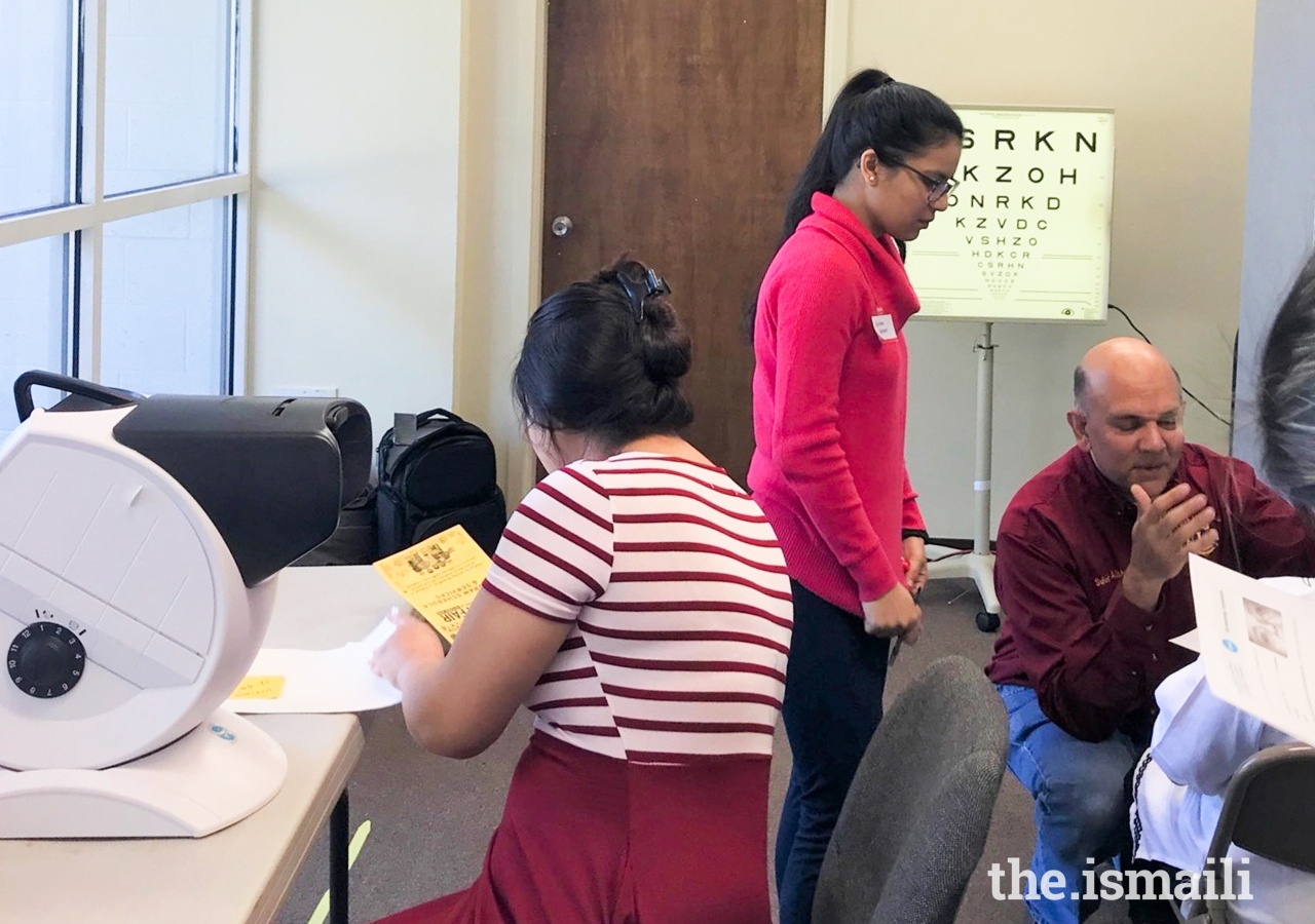 Jamati members get vision screenings.