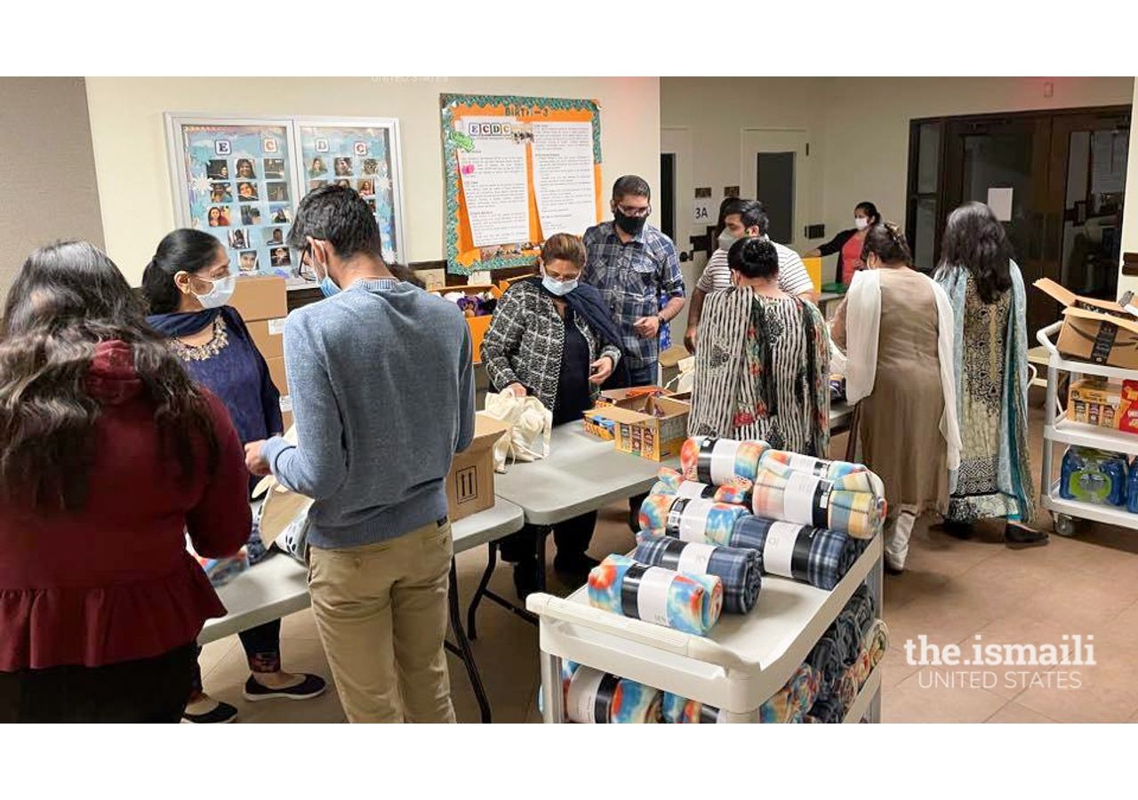 Ismaili volunteers prepare welcome bags with comfort items for the arriving Afghans.