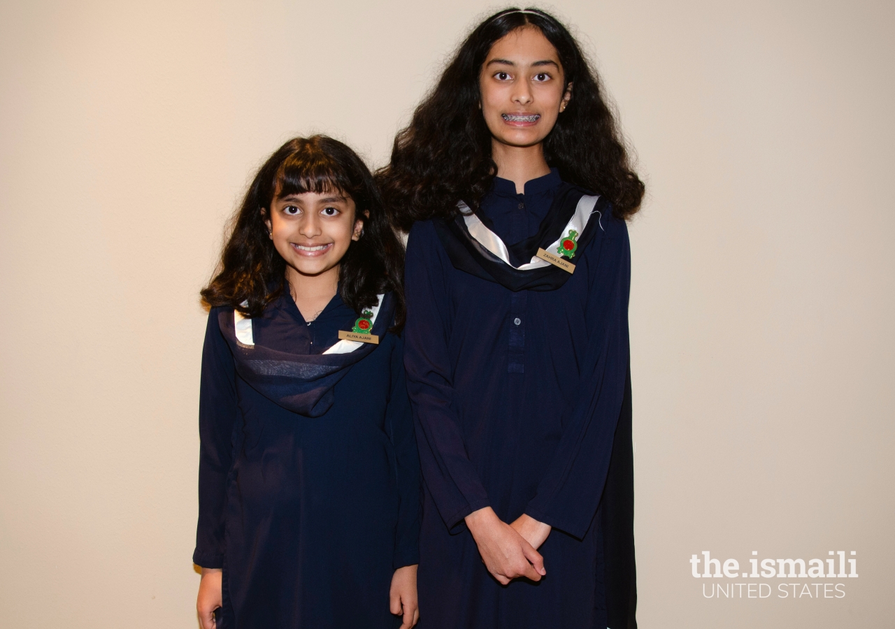 Young Houston volunteers Zahra and Aliya Ajani, great-granddaughters of Sherbano Ajani