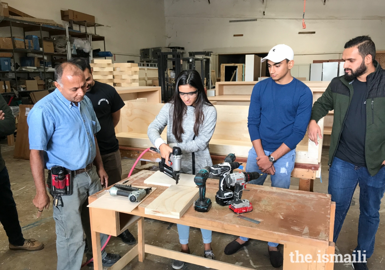 A workshop participant practicing her skills with the help of an IMARA team member.