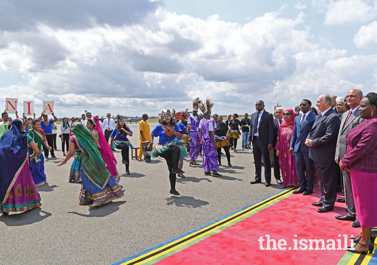 Mawlana Hazar Imam views a cultural "Ngoma" dance performed by Ismaili Volunteers at the Julius Nyerere Airport. 