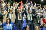 Prince Rahim joins in on an audience wave while taking in a match at the Jubilee Games. JG/Pervaiz Akhtar