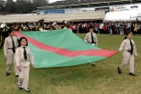 Young Ismaili girls and boys carry the Ismaili Flag with pride. 