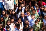 President Marcelo surrounded by Ismaili youth in the Garden of Fruits at the Ismaili Centre, Lisbon. 