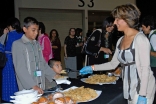 A volunteer smiles as she serves food at ExCeL London. 