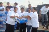 Volunteers from FOCUS Humanitarian Assistance unload water for people affected by Hurricane Ike at a Houston Point of Distribution. 