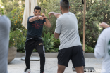 Three-time world jiu-jitsu champion Moiz Lakhani instructing a kickboxing class for participants.