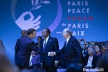 President Emmanuel Macron welcomes Mawlana Hazar Imam to the opening session of the Paris Peace Forum while President Paul Biya of Cameroon looks on.