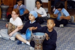 School children learn to play the daf, an Iranian percussion instrument.