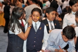 Youth volunteers take a moment to join in the fun and have their faces painted.
