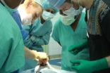 Medical professionals gather in a surgical theatre in Kinshasa to operate on a young patient. In addition to correcting patients’ facial deformities, Operation Smile gives local trainees a chance to learn from experts in their field.