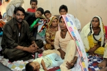 A family finds shelter from the flood devastation at a FOCUS relief camp in Sindh.