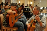 During rehearsal, Paul Griffiths works with a Syrian musician from the UAE Jamat.
