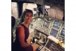 Farah sitting in the space shuttle simulator during a trip to NASA's Kennedy Space Center.