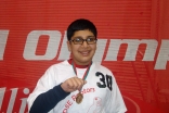 Asad smiles after winning the Gold Medal in Basketball Individual Skills at the 2010 Illinois State Special Olympics.