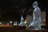 A view of the Tolerance sculptures along Allen Parkway at night time.