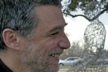 Jaume Plensa at the Tolerance dedication ceremony held at Harmony Walk, with one of the sculptures visible in the background.