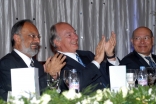 Mawlana Hazar Imam applauds during the institutional dinner, together with Ismaili Council President Aitmadi Zul Abdul and AKDN Resident Representative Aitmadi Aziz Bhaloo.