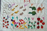 Numbers 1 – 10 in Dari with pictures sewn by mothers for the Sparks Early Childhood Development Program.