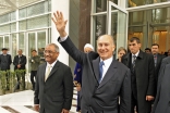 As he departs the Dushanbe Serena Hotel, Mawlana Hazar Imam waves at members of the Jamat gathered across the street.