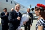 Upon his arrival, Mawlana Hazar Imam is greeted by volunteers with flowers in the presence of His Excellency Hamrokhon Zarifi, Minister of Foreign Affairs of the Republic of Tajikistan, Dr Shafik Sachedina, Director of Diplomatic Affairs at the Aga Khan D