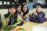 Children at Bait-ul Ilm snack on a healthy plate of vegetables.