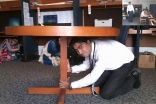 Staff at the Aga Khan University in Karachi Drop, Cover and Hold on during the AKDN ShakeOut drill.