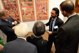 A guide explains the exhibition to guests at the Enlightened Encounters outreach event held at Chicago Headquarters Jamatkhana in Glenview, IL.