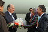 Mawlana Hazar Imam is presented with a bouquet of flowers by AKDN Resident Representative Nurjehan Mawani upon his arrival in Kabul, as Ismaili Council for Afghanistan President Shair Baz Hakemy looks on.