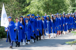 The student procession makes their way towards the graduation hall at UCA’s Naryn campus.