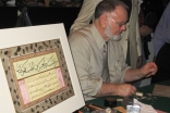 Zakariya demonstrating the art of calligraphy during the workshop session.     