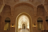 The main entrance hall of the Ismaili Centre, Dubai draws architectural inspiration from Fatimid mosques. At the centre of the colourfully patterned marble floor is an ornamental fountain crafted from a solid block of Carrara marble.