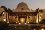 The entrance of the Ismaili Centre, Dubai is adorned by fountains, trees and a five-arched teak and meranti portico.