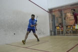 Youth playing a game of squash 