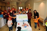 Volunteers of all ages celebrate as they exceed the goal of packing 60,000 meals in celebration of 60 years of Imamat.