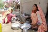 A housewife and her daughter in Ishaq Holani village in Sind using an energy efficient stove