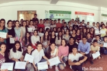 Students from grades eight and ten join Aziz Batada, and TKN volunteers Ashna Suchak and Kais Khimji for a group photograph.