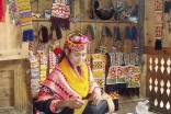 FMFB-P has provided micro loans in the mountainous valley of Chitral called Kalash where this women is making a traditional Kalashi dress in her small shop. Taking a micro loan allows women like this one to send her children to school.