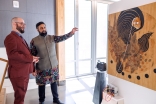 Event co-host Munir Meghjani and a guest viewing the art gallery