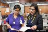 AKU nurses Salima Pirani (Dallas) and Amina Huda (California) review patient records during their volunteer shift.