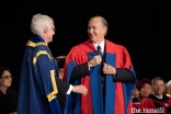 SFU President and Vice-Chancellor Andrew Petter adjusts the ceremonial SFU robe on Mawlana Hazar Imam as part of honorary degree conferral ceremony.