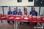 The Jamati Members and volunteers embracing the counter showcasing many types of bird feeders which would then be distribute among the houses nearby