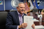 Director of CalOES, Mark Ghilarducci, showed the signed agreement to the other remote participants.