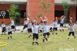 At the Aga Khan Academy in Hyderabad, India, teachers and students enjoy a fun moment of sport together on the campus lawn.