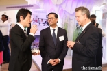 President of the Aga Khan Council for Southwestern United States Murad Ajani, engages with guests viewing the AKDN Ethics in Action exhibit.