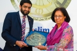 Dr Amina Jindani receives an award in 2018 from Iqbal Nasim, Chief Executive, National Zakat Foundation.