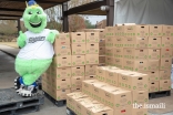 Swatson, mascot of the Sugar Land Skeeters, posing next to a few of the donated food items., Over 30,000 pounds of food were collected at the Ismaili Jamatkhana and Center and donated to the East Fort Bend Human Needs Ministry in Stafford, Texas. 