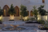 The main courtyard at the Ismaili Centre Dubai features an intricate geometric arrangement of water channels which, along with the flower beds and trees, evoke the natural environment within a built-up area.